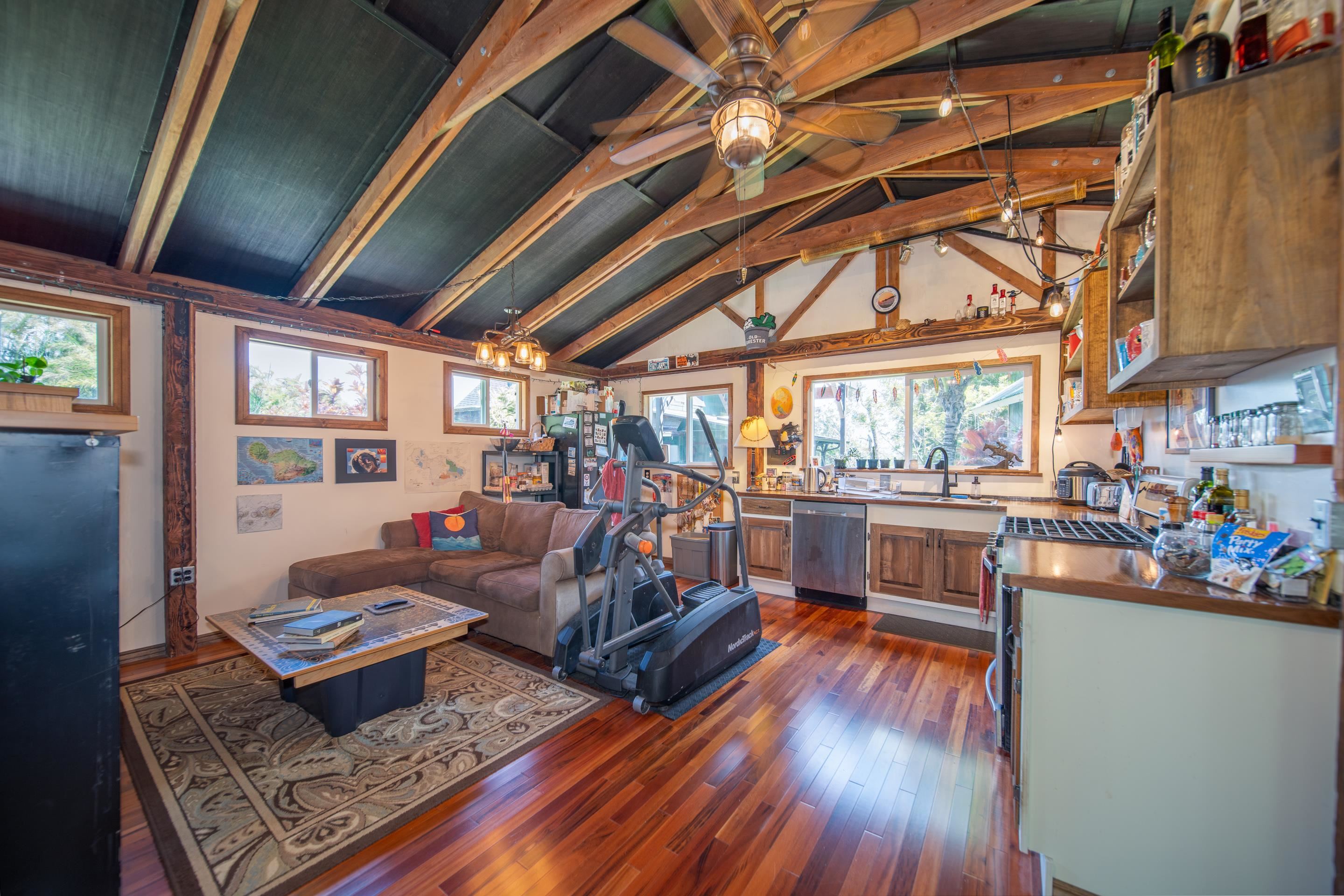 55 Oluolumau Place Haiku, HI 96708 - Photo 26 of 30 a living room with lots of furniture and a kitchen view