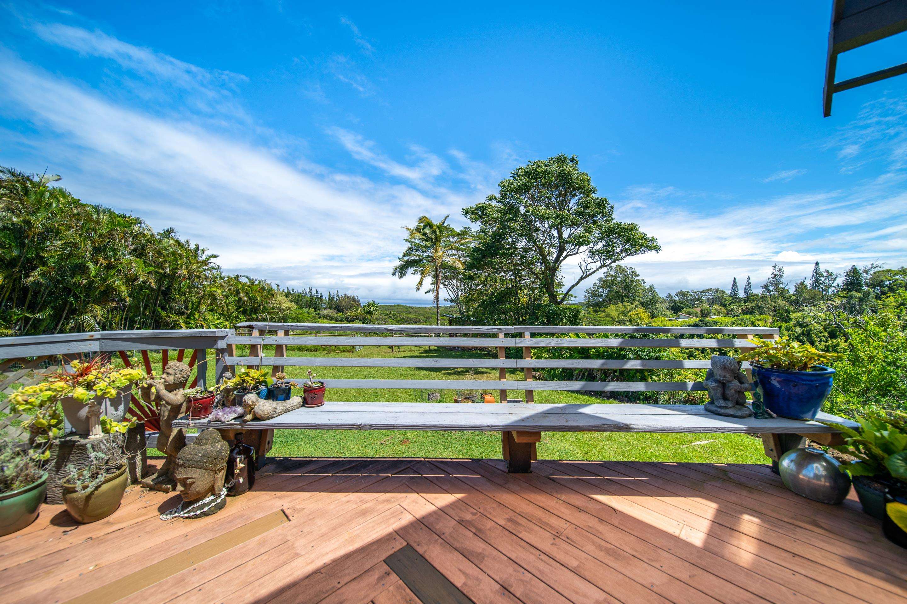 55 Oluolumau Place Haiku, HI 96708 - Photo 7 of 30 a view of a deck with a big yard