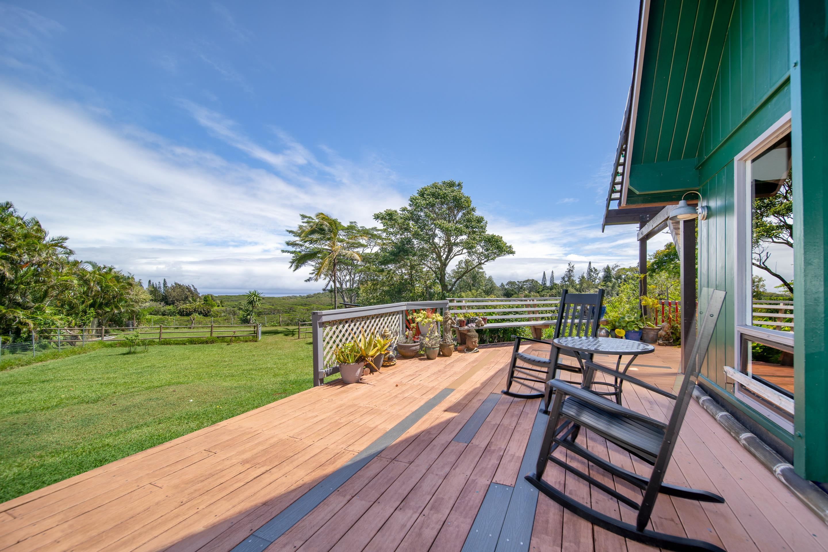 55 Oluolumau Place Haiku, HI 96708 - Photo 8 of 30 a view of a chairs and table on the wooden deck