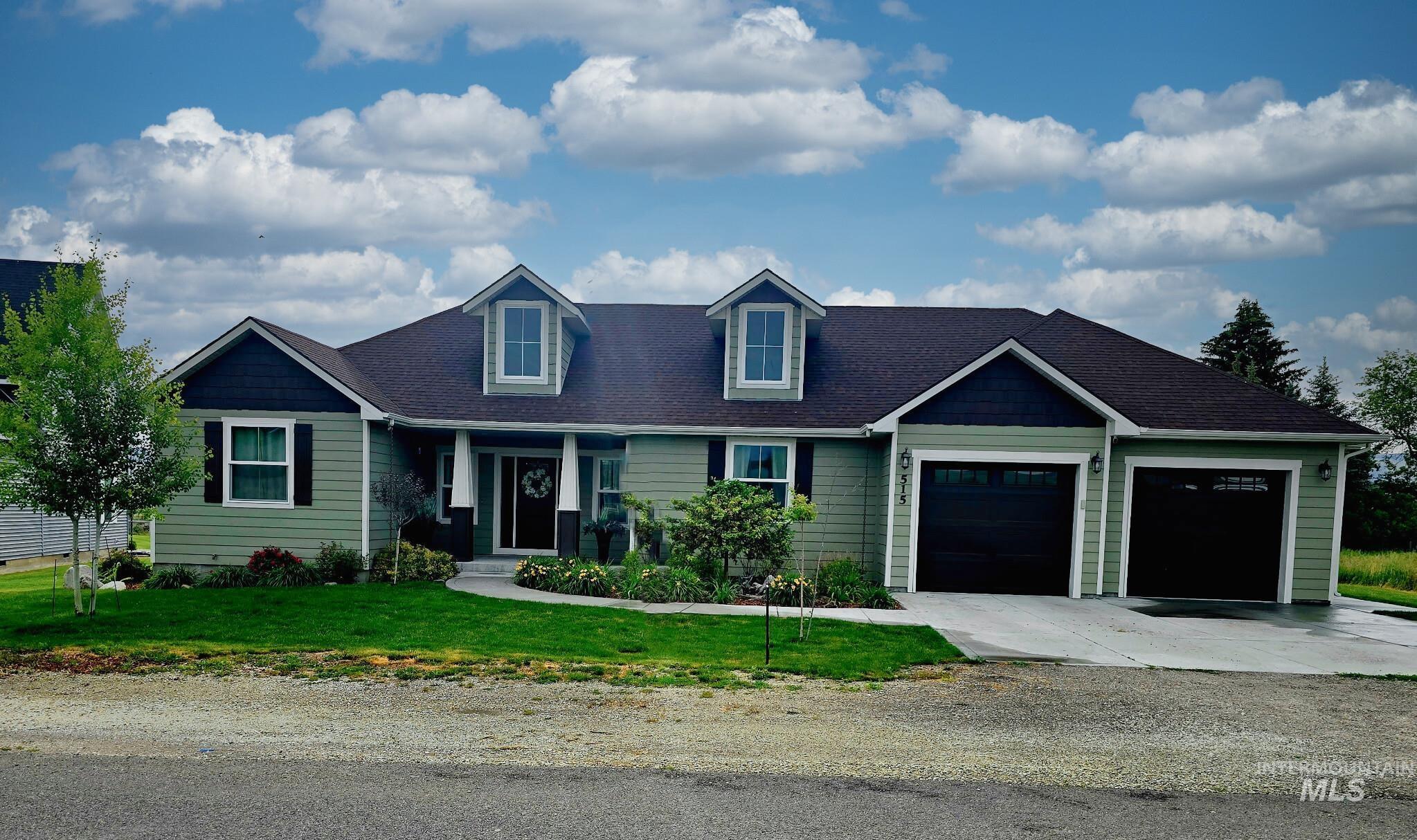 515 School Street Albion, ID 83311 - Photo 1 of 30 View of front of property featuring a front lawn, a garage, driveway, and roof with shingles