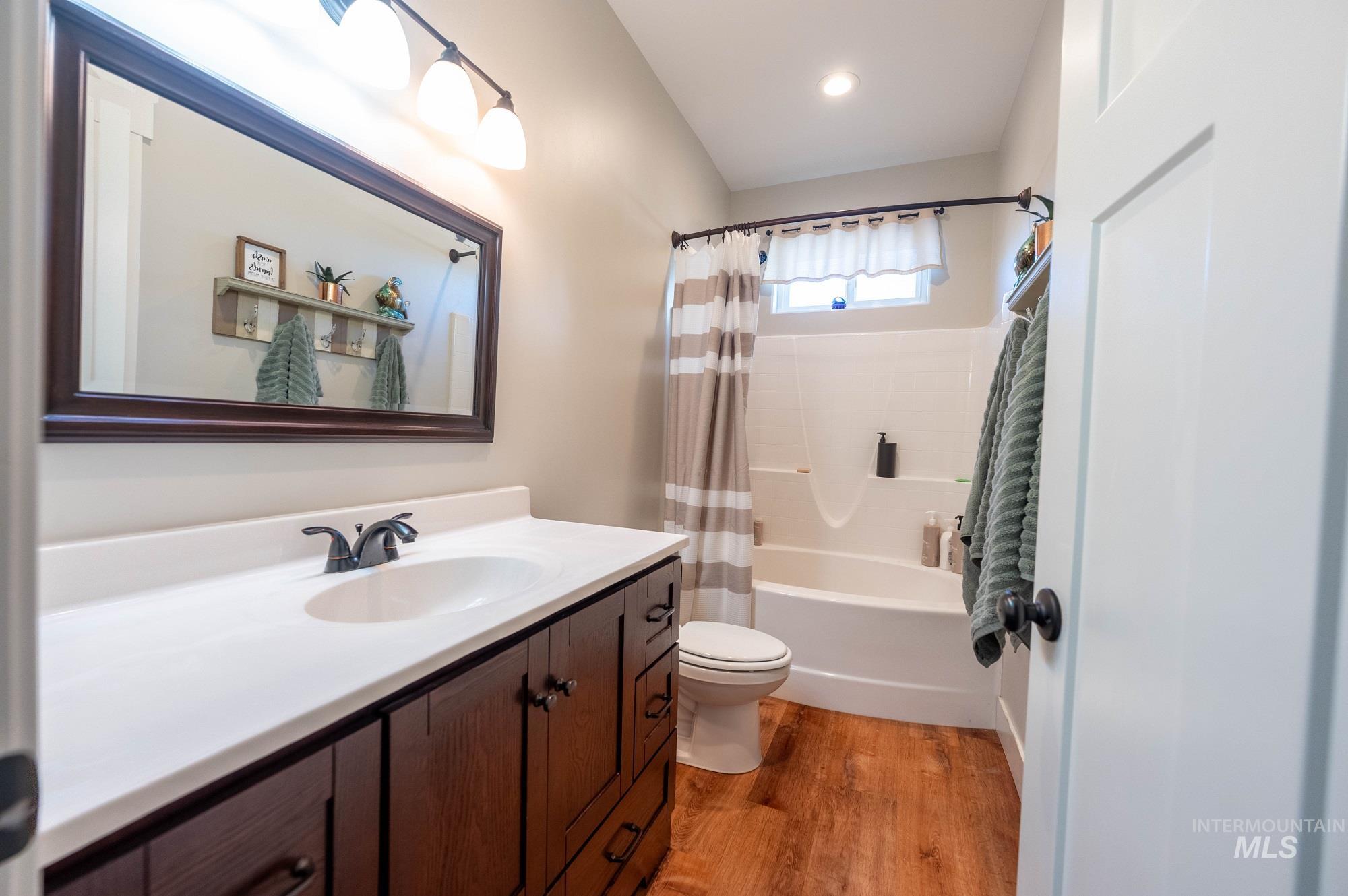 515 School Street Albion, ID 83311 - Photo 18 of 30 Full bath with vanity, shower / bath combo with shower curtain, and light wood-style flooring