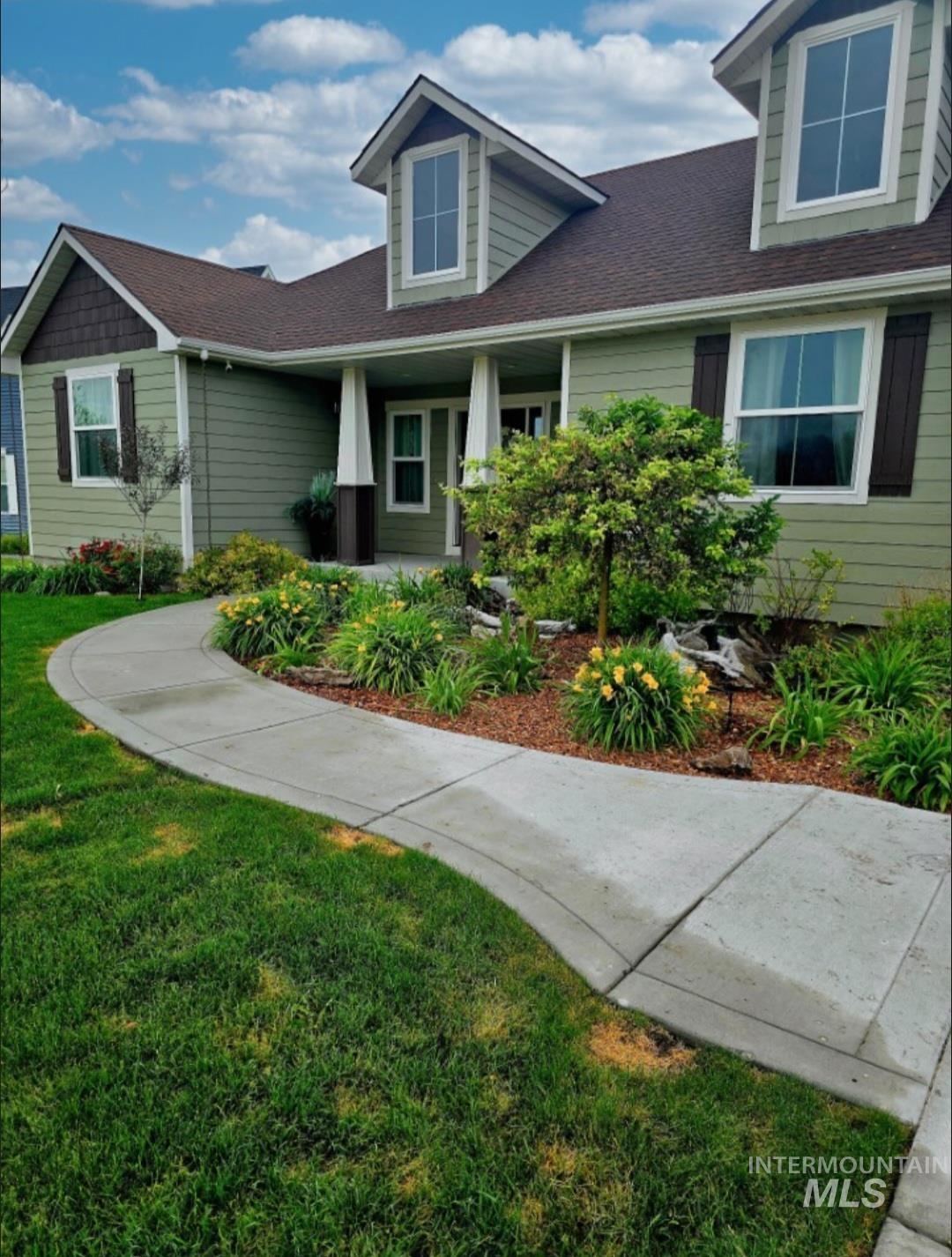 515 School Street Albion, ID 83311 - Photo 26 of 30 View of front facade with a front yard, a shingled roof, and covered porch