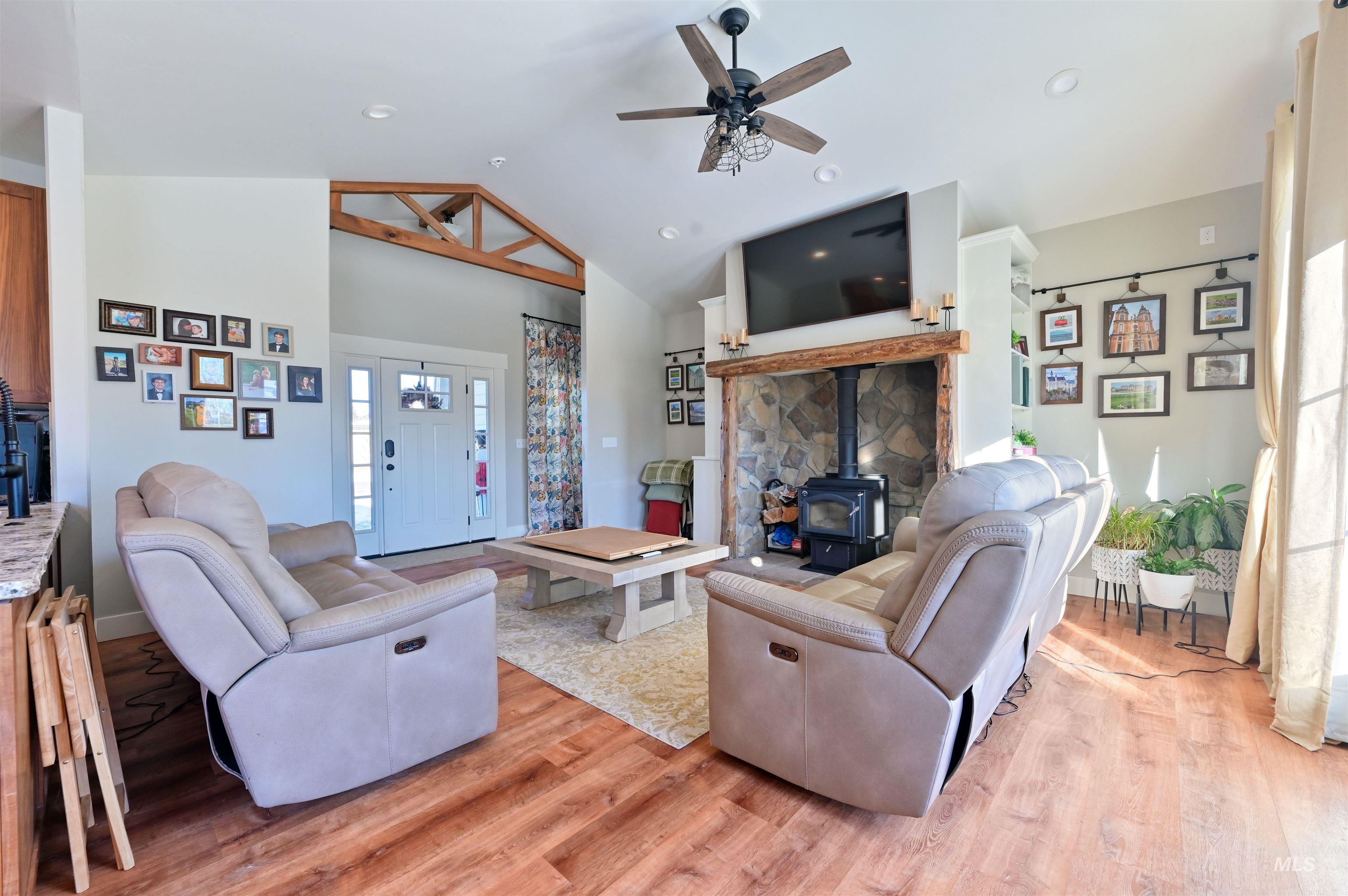 515 School Street Albion, ID 83311 - Photo 5 of 30 Living room with a wood stove, light wood finished floors, ceiling fan, high vaulted ceiling, and recessed lighting