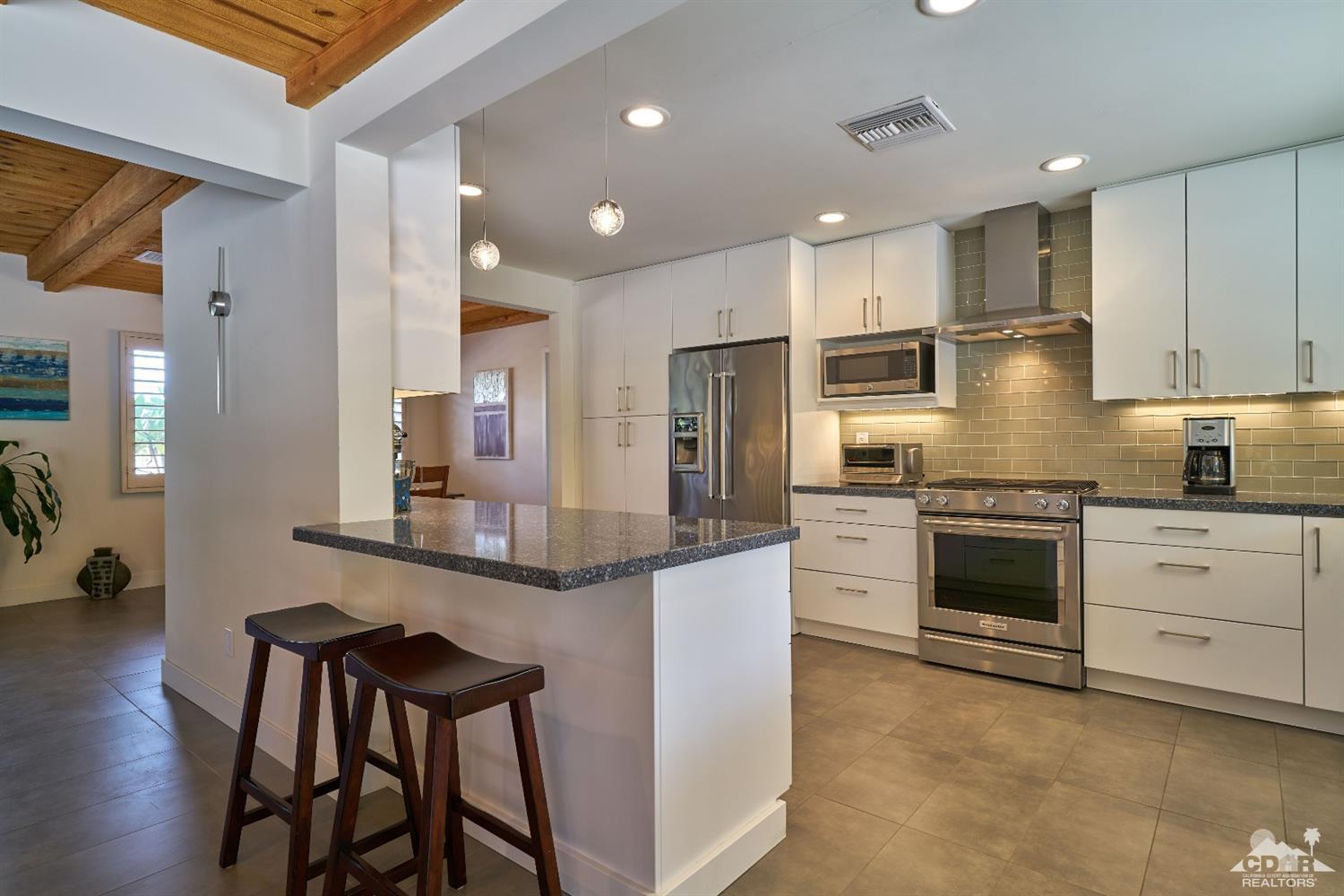71417 Mirage Road Rancho Mirage, CA 92270 - Photo 16 of 25 a kitchen with stainless steel appliances granite countertop a stove refrigerator sink and cabinets