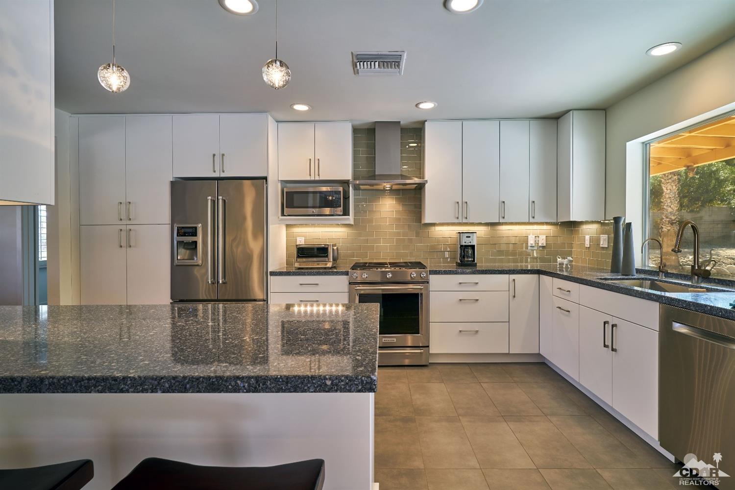 71417 Mirage Road Rancho Mirage, CA 92270 - Photo 17 of 25 a kitchen with a refrigerator sink and cabinets