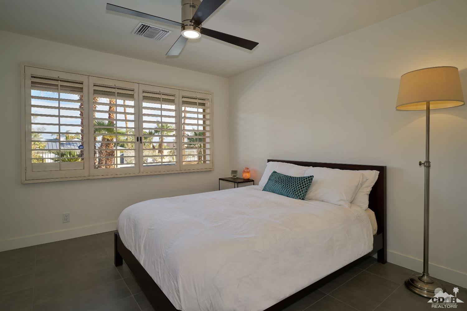 71417 Mirage Road Rancho Mirage, CA 92270 - Photo 20 of 25 a large bed sitting in a bedroom next to a window