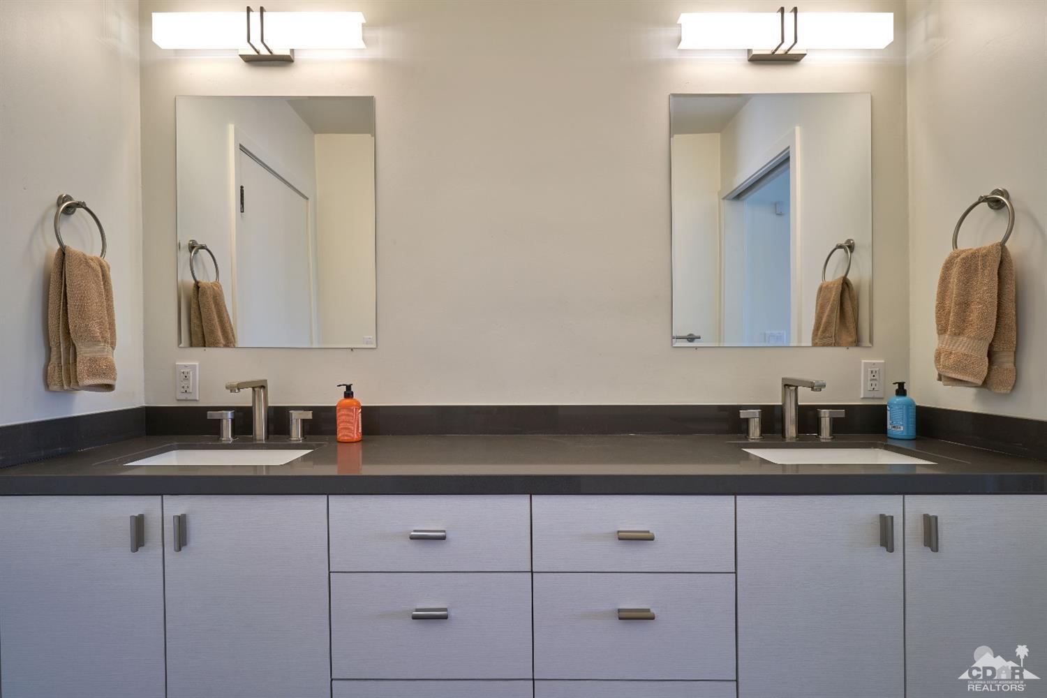 71417 Mirage Road Rancho Mirage, CA 92270 - Photo 21 of 25 a bathroom with double vanity sinks a vanity and a mirror