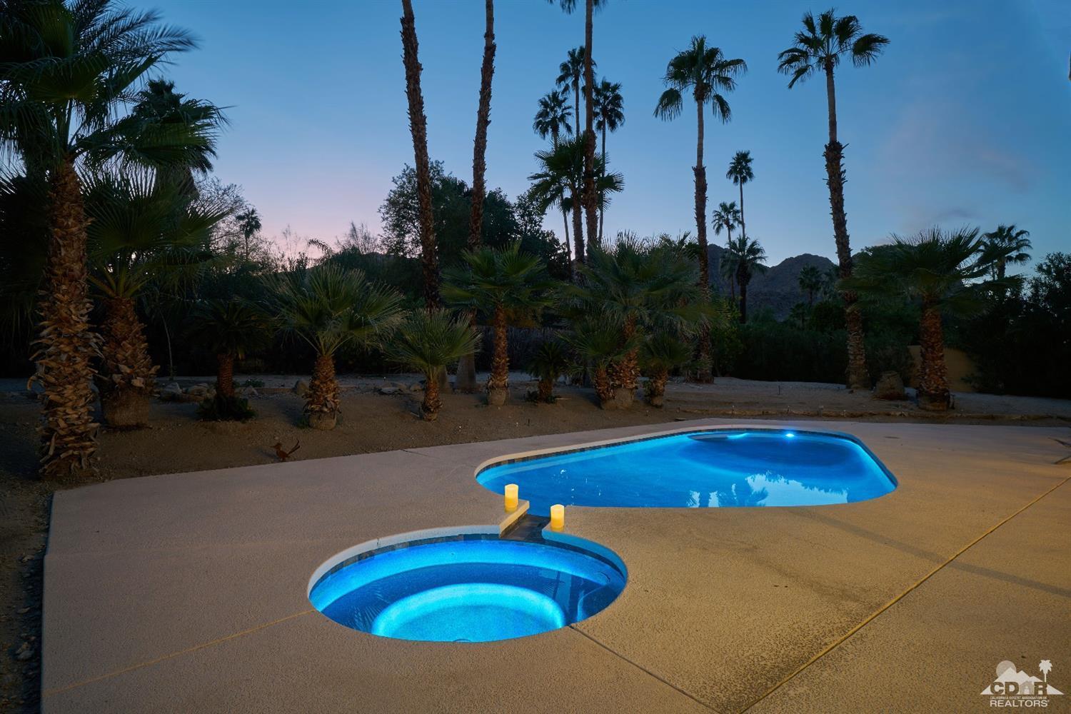 71417 Mirage Road Rancho Mirage, CA 92270 - Photo 3 of 25 a view of a swimming pool with a yard and palm trees