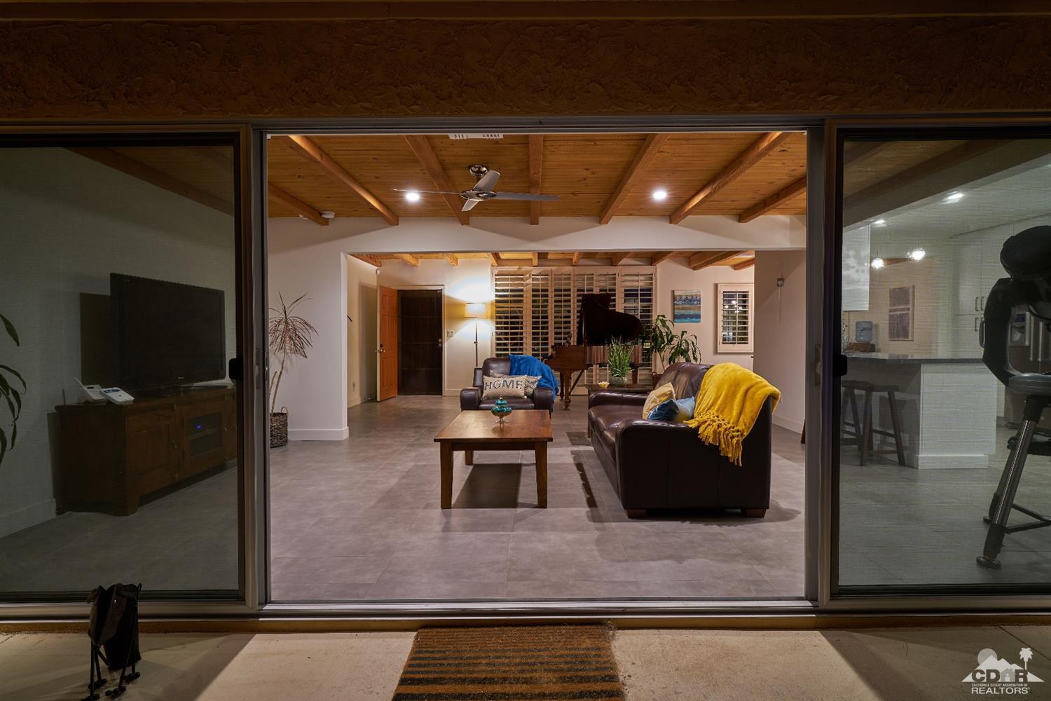 71417 Mirage Road Rancho Mirage, CA 92270 - Photo 7 of 25 a living room with furniture and a glass door