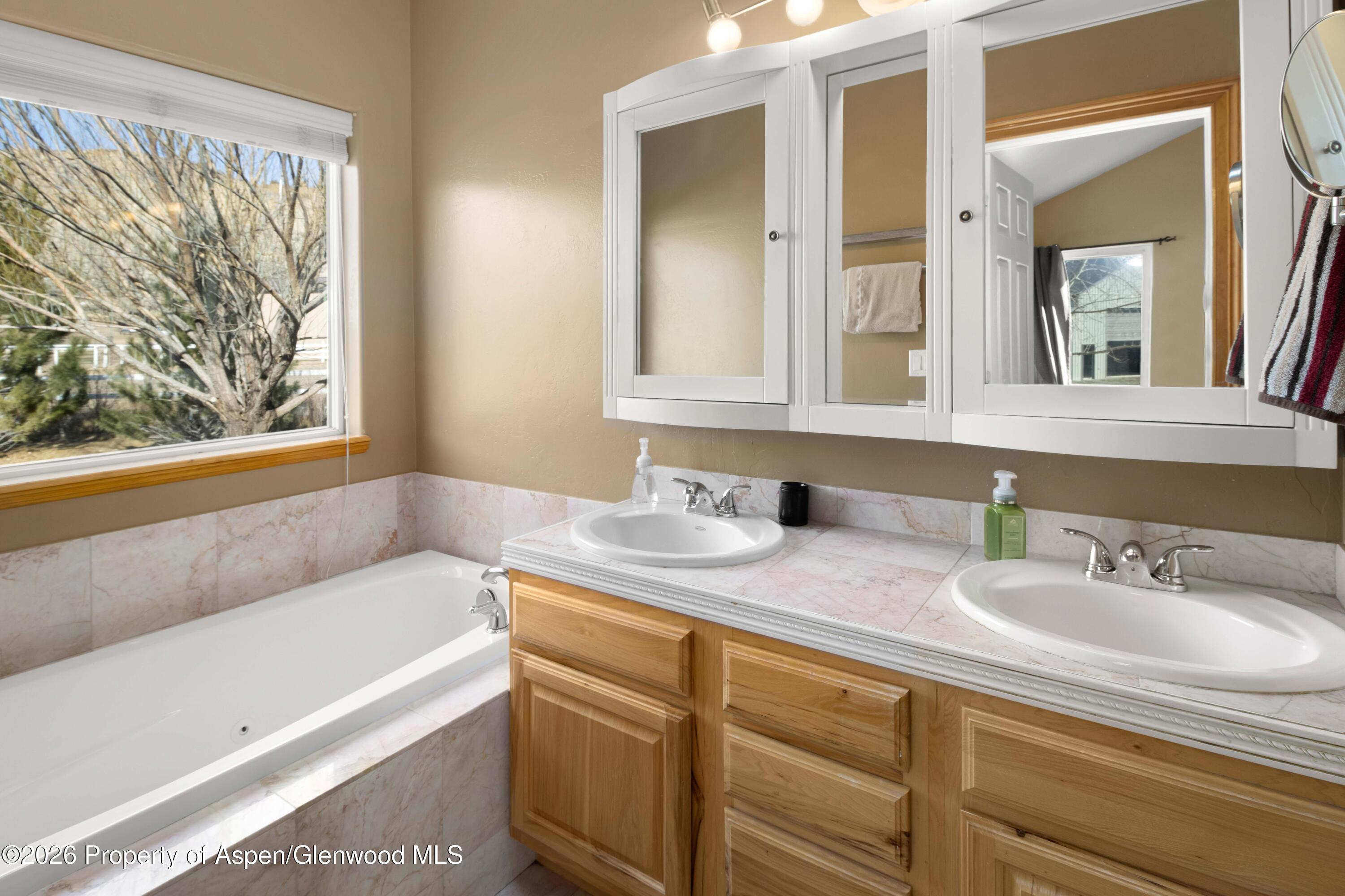 83 Native Springs Drive Rifle, CO 81650 - Photo 13 of 31 a bathroom with a granite countertop sink and a mirror
