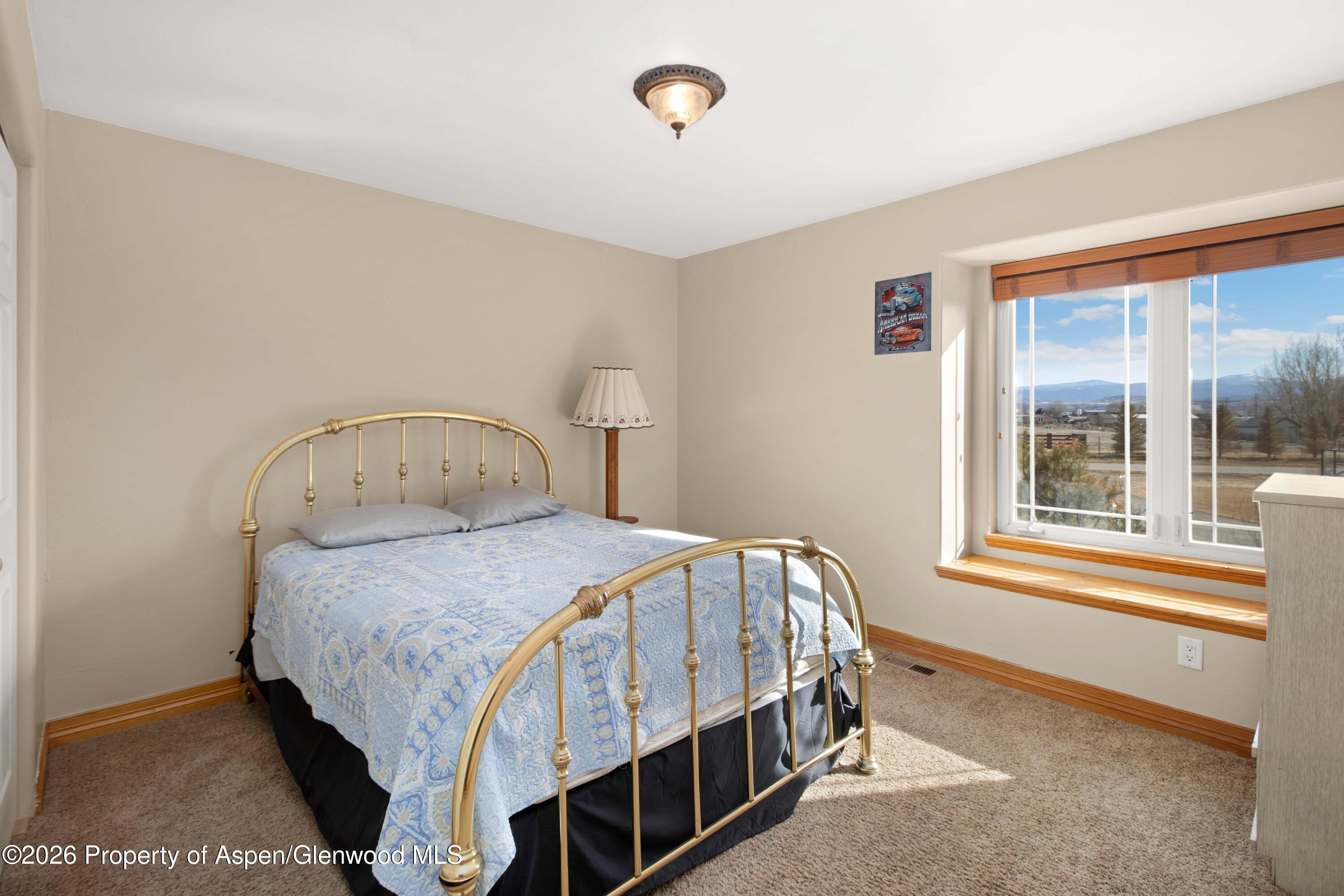 83 Native Springs Drive Rifle, CO 81650 - Photo 15 of 31 a bedroom with a bed next to a window