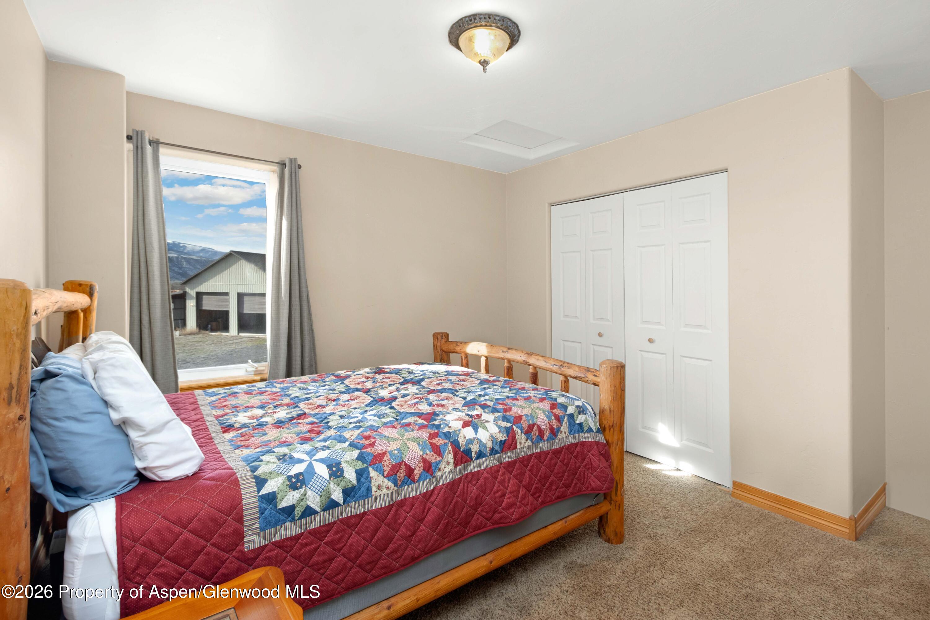 83 Native Springs Drive Rifle, CO 81650 - Photo 24 of 31 a bed sitting in a bedroom next to a window