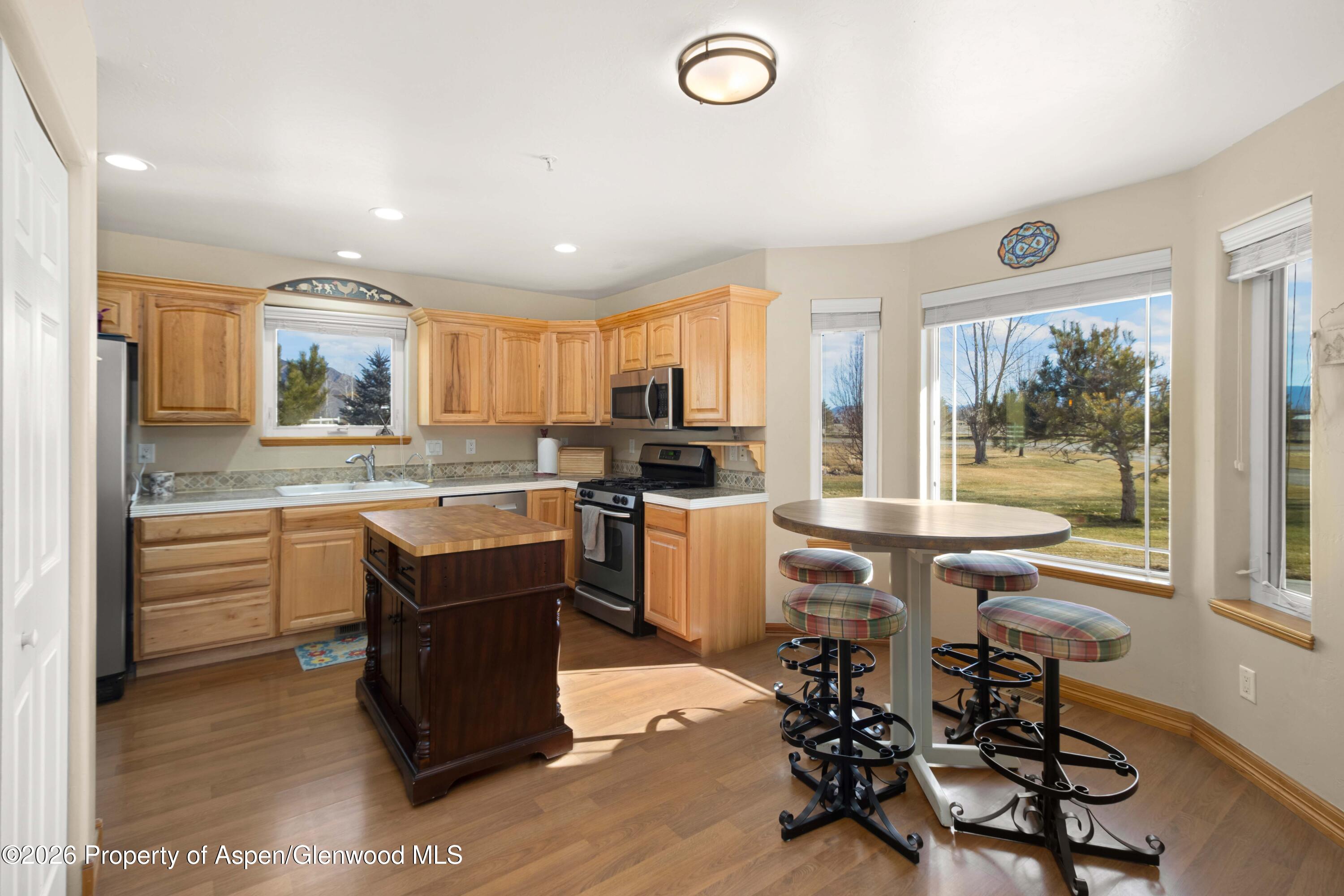 83 Native Springs Drive Rifle, CO 81650 - Photo 10 of 31 a kitchen with a table chairs microwave and cabinets