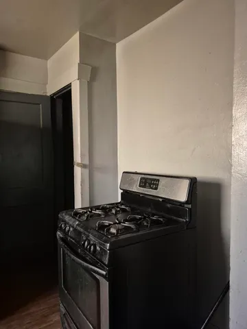 a stove top oven sitting inside of a kitchen