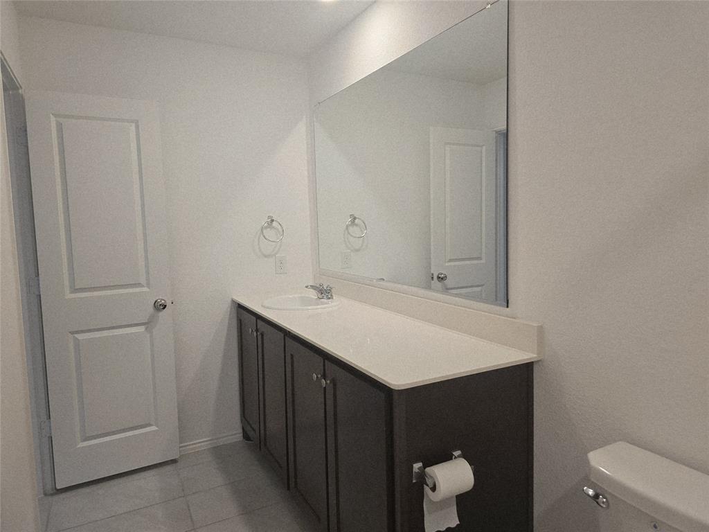 14017 Ilderton Street Pilot Point, TX 76258 - Photo 13 of 22 a bathroom with a sink vanity and mirror