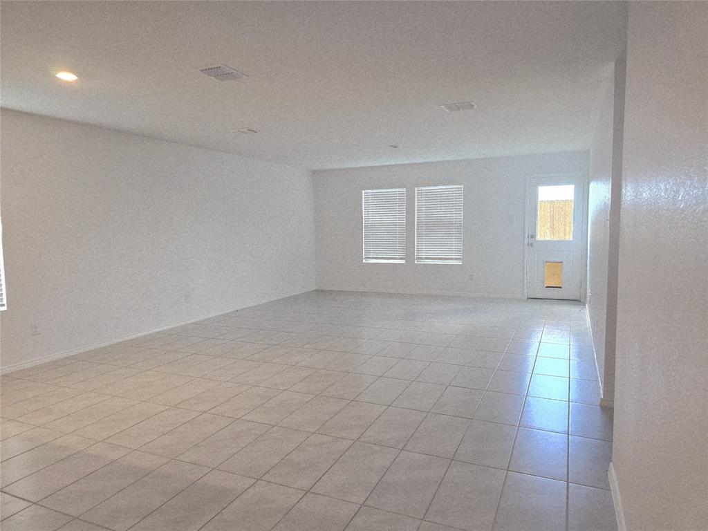 14017 Ilderton Street Pilot Point, TX 76258 - Photo 4 of 22 an empty room with white walls and windows
