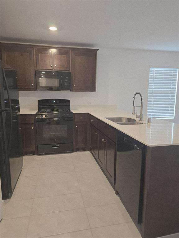 14017 Ilderton Street Pilot Point, TX 76258 - Photo 5 of 22 a large kitchen with granite countertop a stove a sink and a microwave