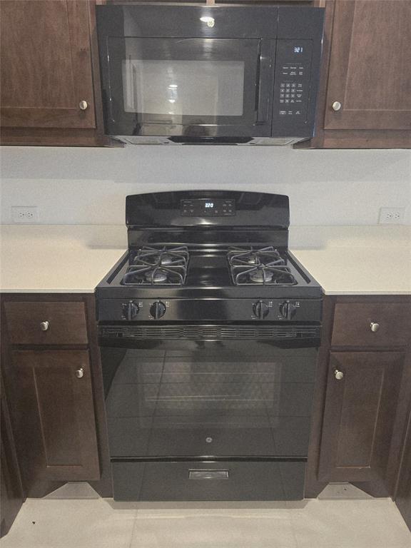 14017 Ilderton Street Pilot Point, TX 76258 - Photo 6 of 22 a stove top oven sitting inside of a kitchen
