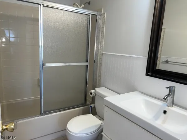 a white toilet sitting next to a bathroom sink