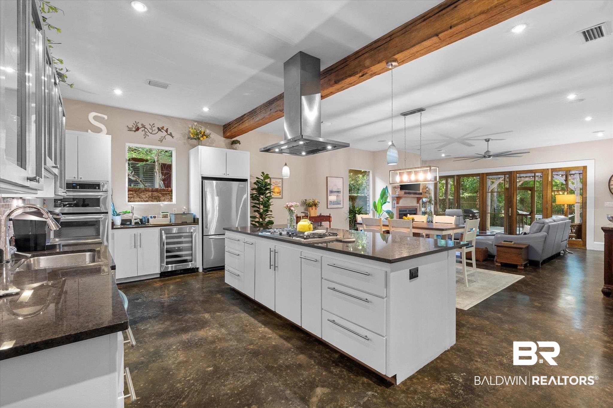 3400 Rue Royal Mobile, AL 36693 - Photo 11 of 33 Kitchen with concrete floors, recessed lighting, island range hood, a center island, and beam ceiling