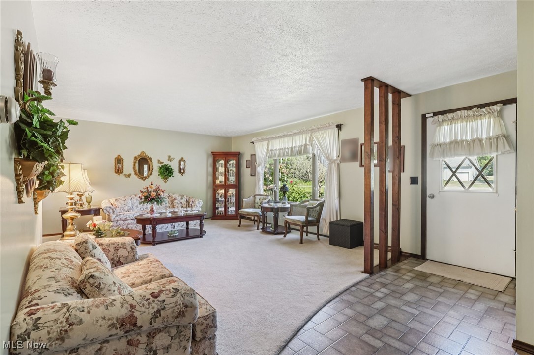 Formal Living room (carpeted) & Foyer with laminate flooring)