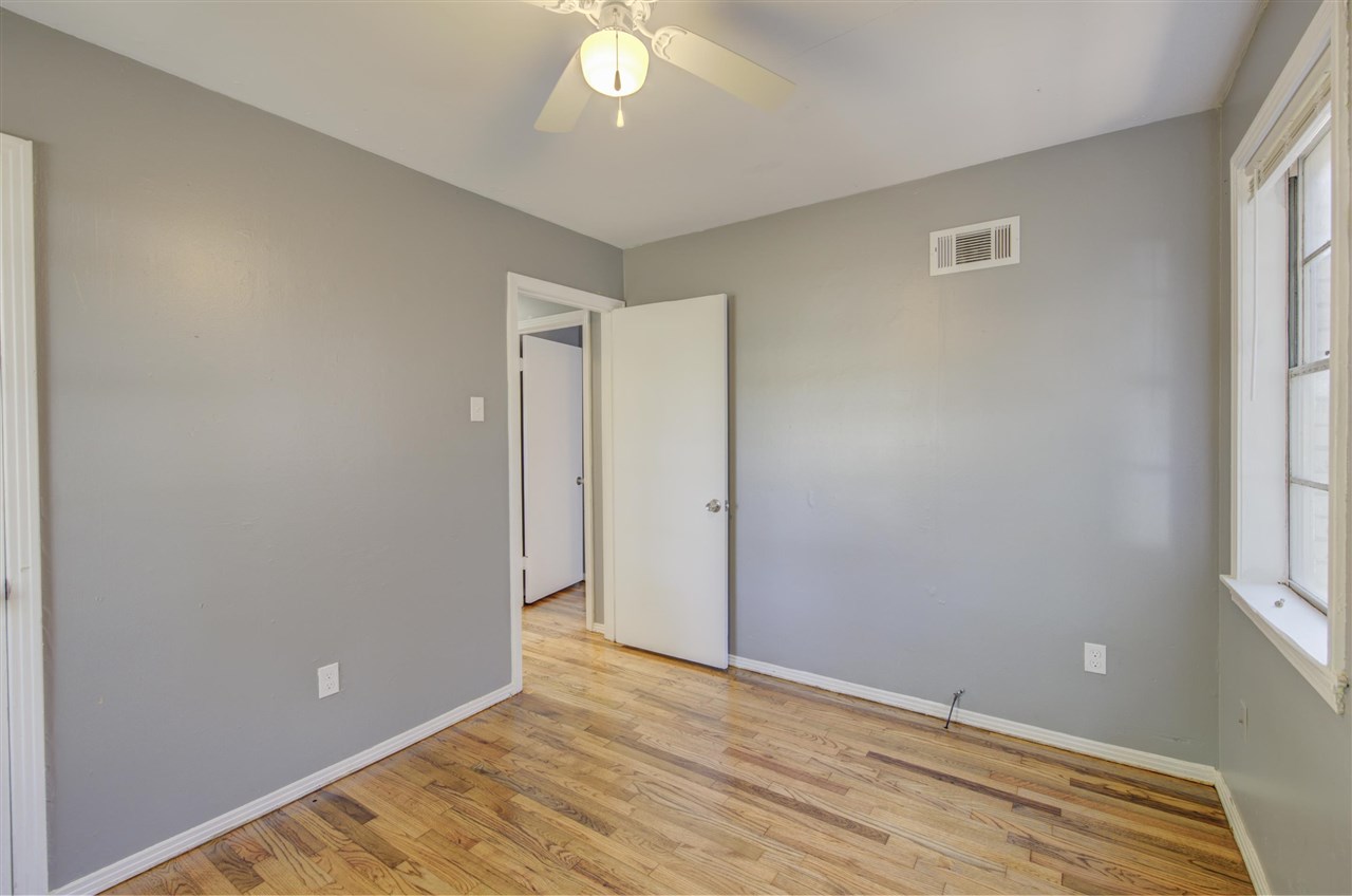 3574 Carrington Road Memphis, TN 38111 - Photo 14 of 22 an empty room with wooden floor and windows