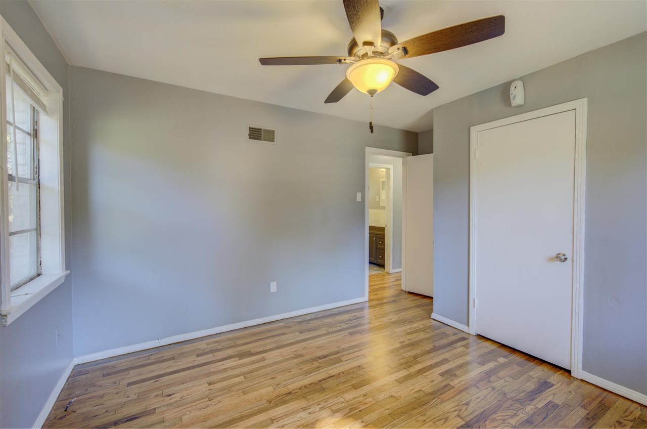 3574 Carrington Road Memphis, TN 38111 - Photo 16 of 22 an empty room with wooden floor and windows