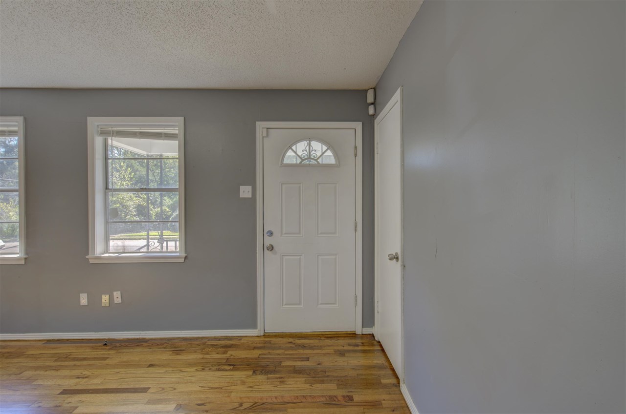 3574 Carrington Road Memphis, TN 38111 - Photo 3 of 22 a view of an empty room with window and wooden floor