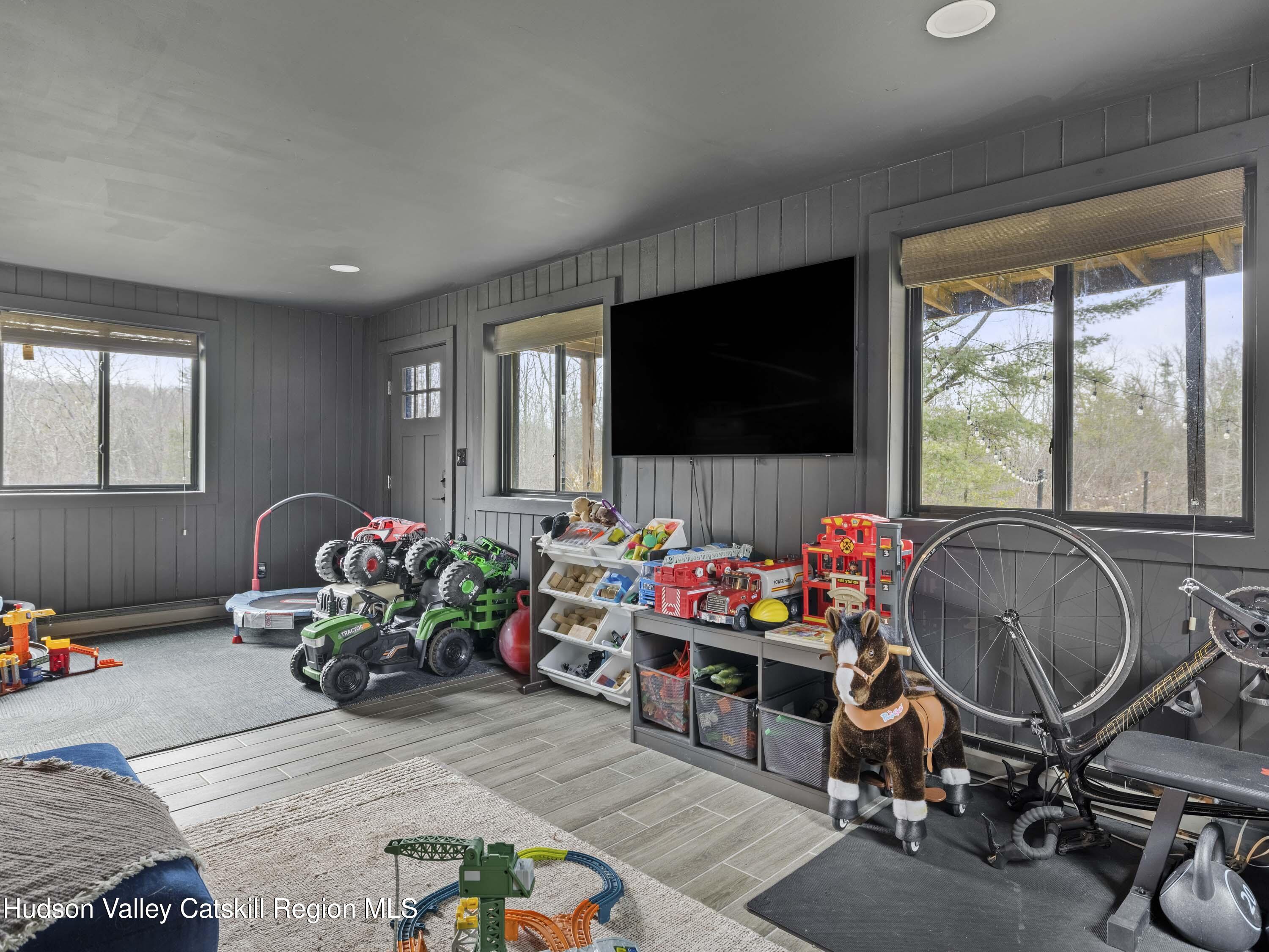 85 Bobillen Road Jewett, NY 12444 - Photo 20 of 59 a living room filled with furniture and a flat screen tv