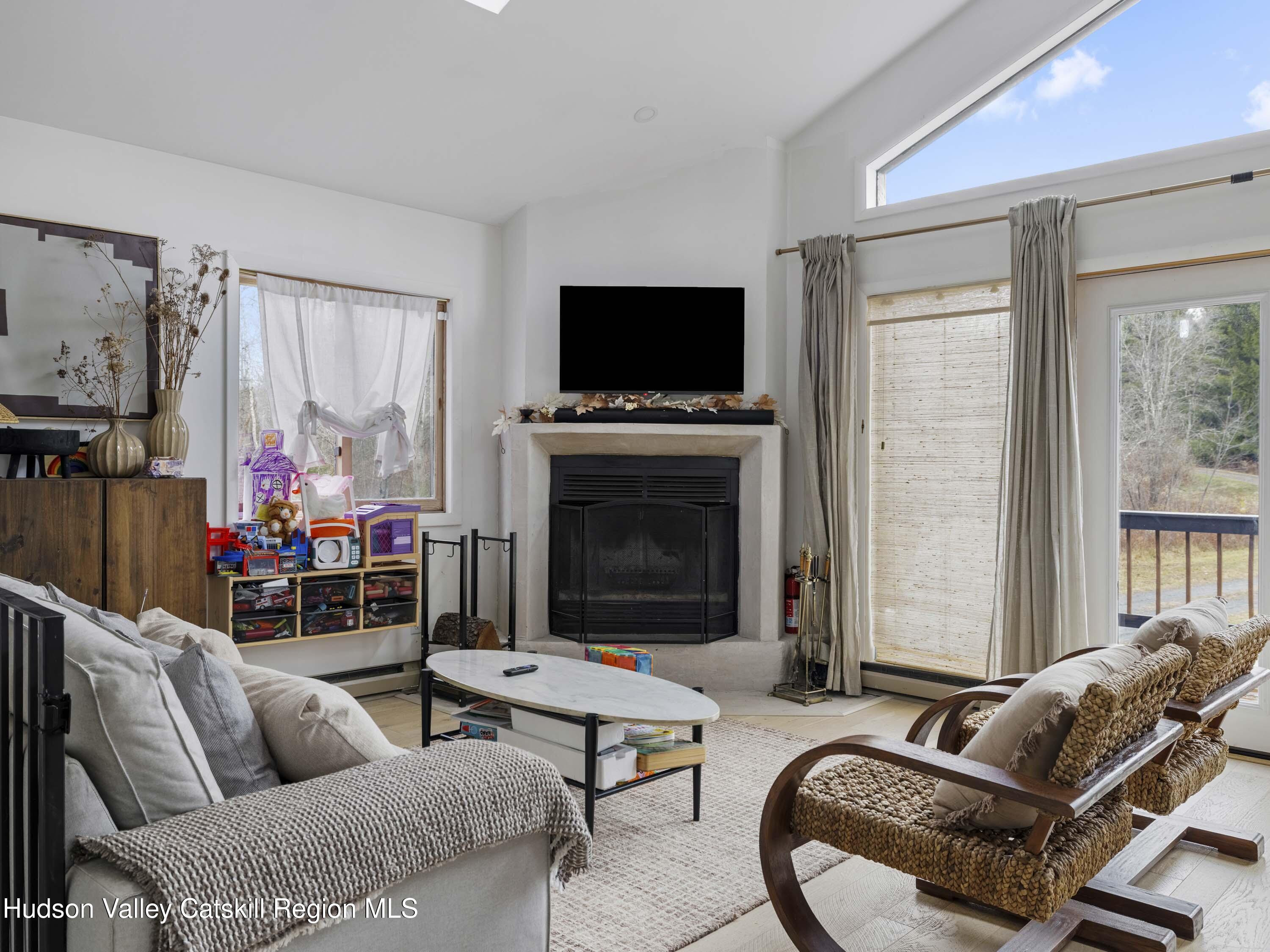 85 Bobillen Road Jewett, NY 12444 - Photo 2 of 59 a living room with furniture a flat screen tv and a fireplace