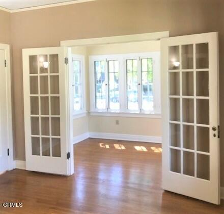 1136 East Rio Grande Street Pasadena, CA 91104 - Photo 19 of 30 an empty room with wooden floor and windows