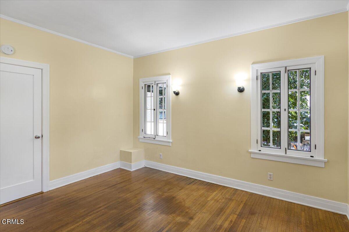 1136 East Rio Grande Street Pasadena, CA 91104 - Photo 22 of 30 a view of an empty room with wooden floor and a window