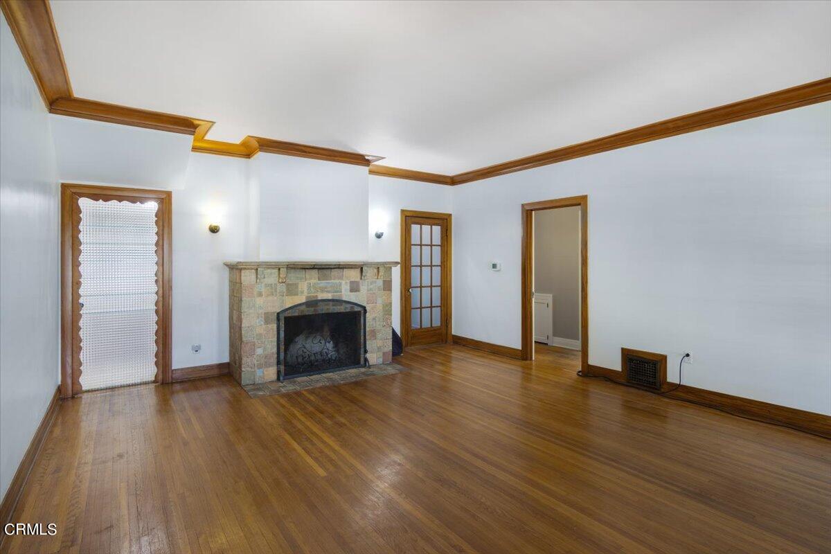 1136 East Rio Grande Street Pasadena, CA 91104 - Photo 7 of 30 a view of a livingroom with wooden floor and a fireplace