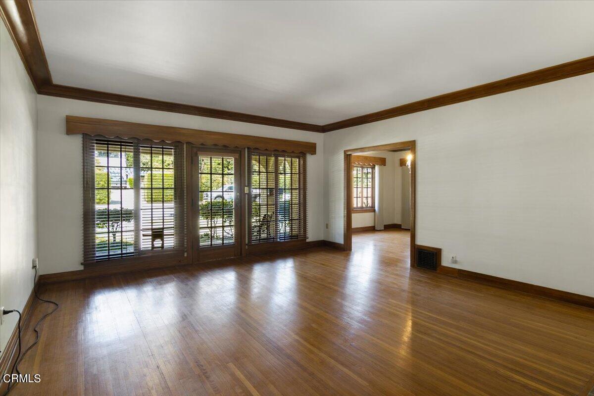 1136 East Rio Grande Street Pasadena, CA 91104 - Photo 9 of 30 a view of an empty room with wooden floor and a window