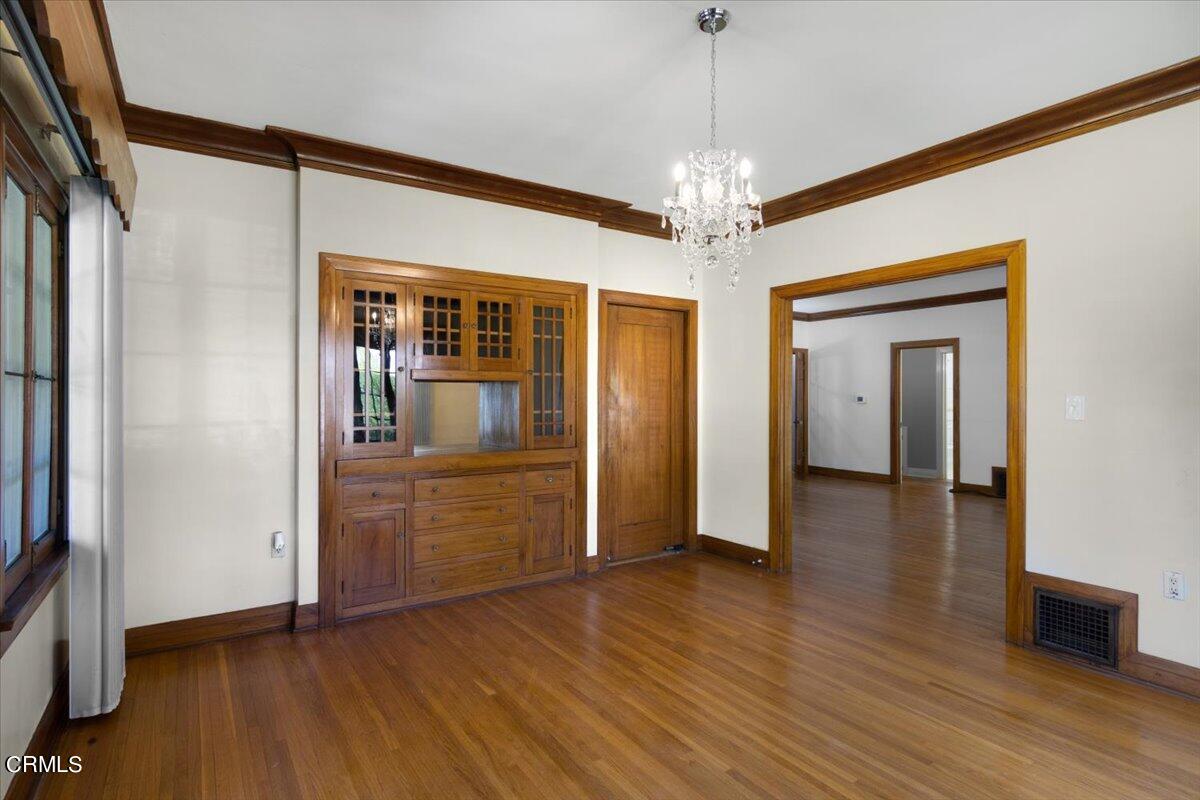 1136 East Rio Grande Street Pasadena, CA 91104 - Photo 10 of 30 a view of a hallway with wooden floor and chandelier