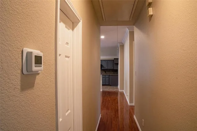 a view of a hallway with wooden floor and staircase