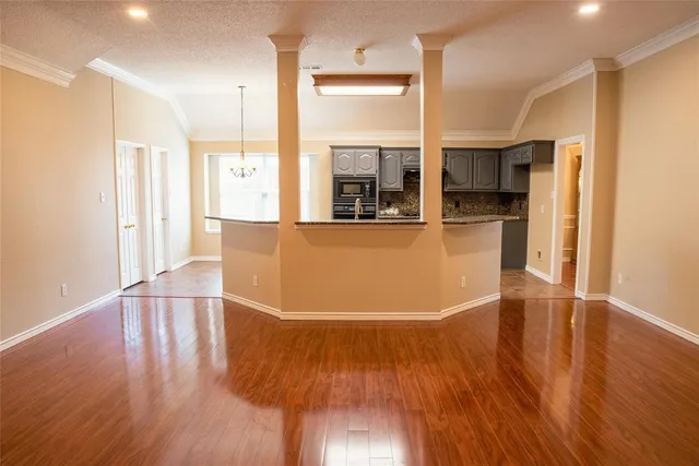 a view of a living room with wooden floor