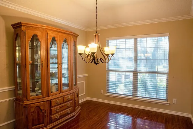 a view of a room with wooden floor and windows