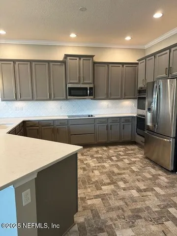 a kitchen with stainless steel appliances a refrigerator and a stove
