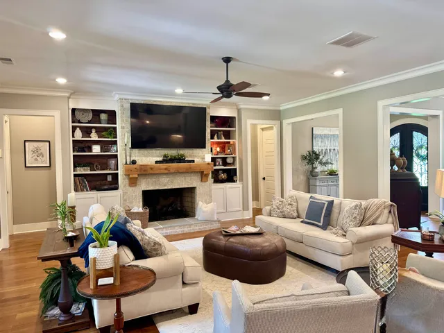 a living room with furniture a flat screen tv and a fireplace