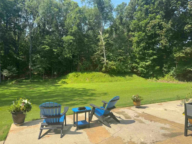 a view of a swimming pool and lounge chairs