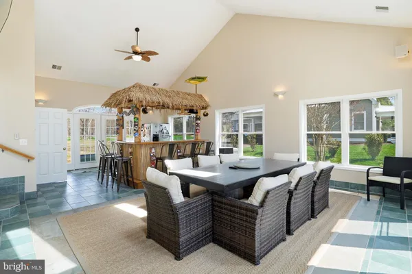 a kitchen with a refrigerator a stove a sink dishwasher with a dining table and chairs