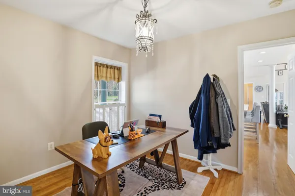 a living room with furniture kitchen view and a large window