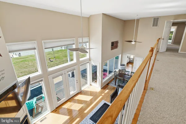 a living room with furniture and large windows