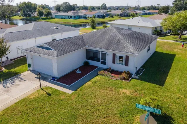 an aerial view of a house having swimming pool and a yard