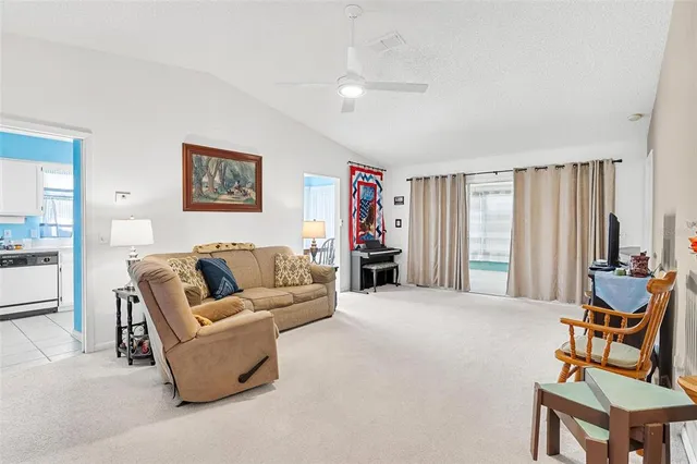 a living room with furniture a flat screen tv and a window