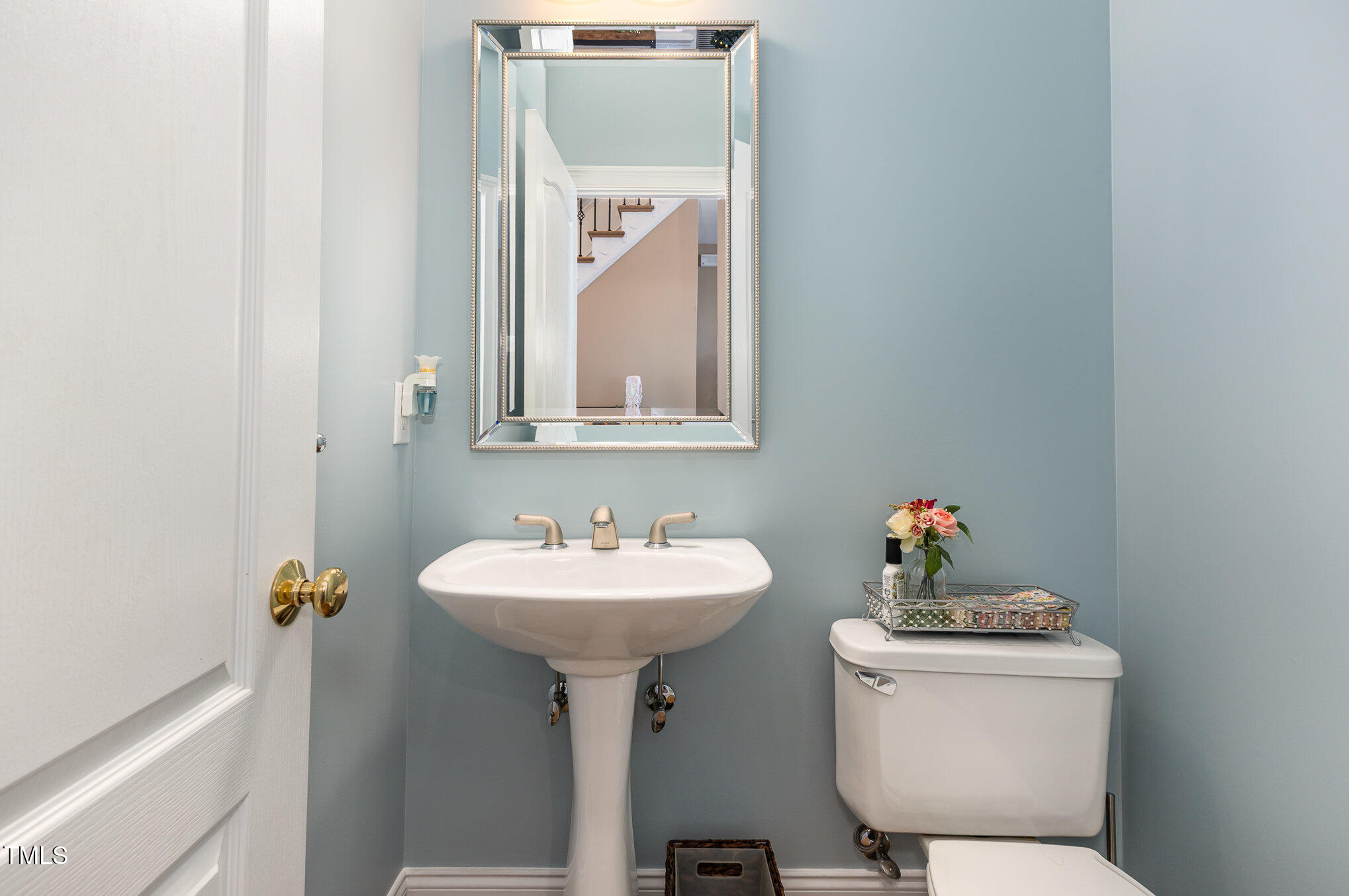 10841 Round Brook Circle Raleigh, NC 27617 - Photo 19 of 44 a bathroom with a toilet sink and mirror