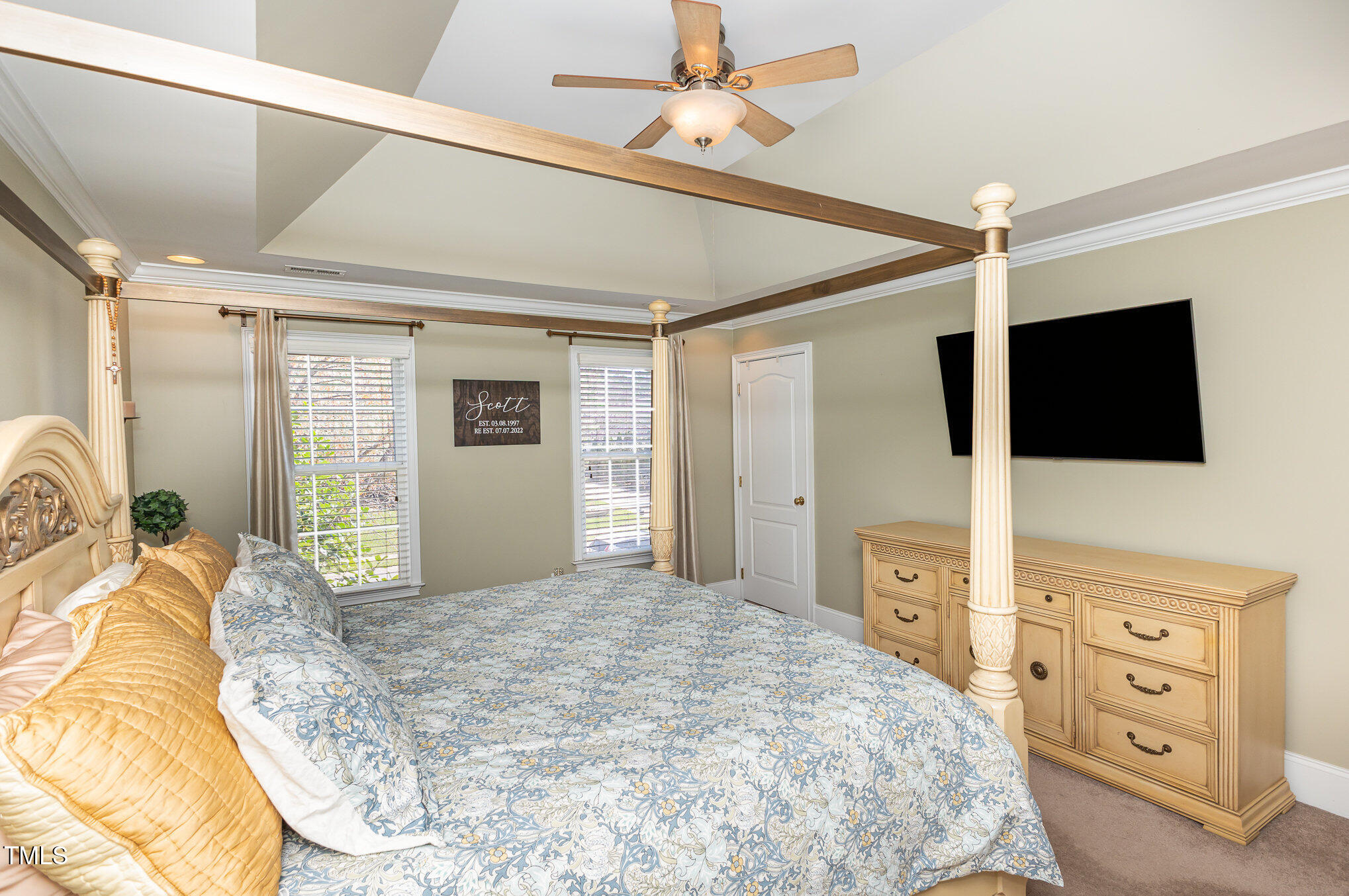 10841 Round Brook Circle Raleigh, NC 27617 - Photo 20 of 44 a bedroom with a large bed and a flat tv screen on dresser