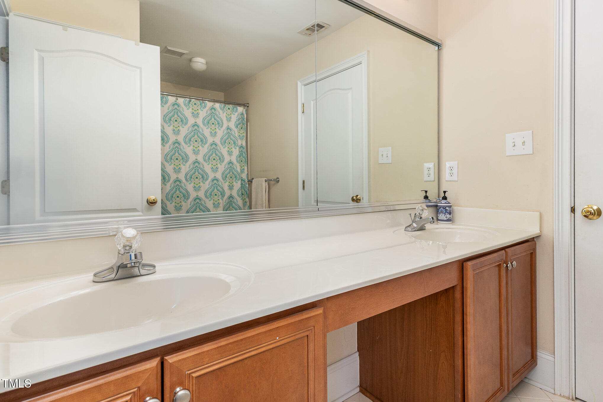 10841 Round Brook Circle Raleigh, NC 27617 - Photo 25 of 44 a bathroom with a sink and a mirror