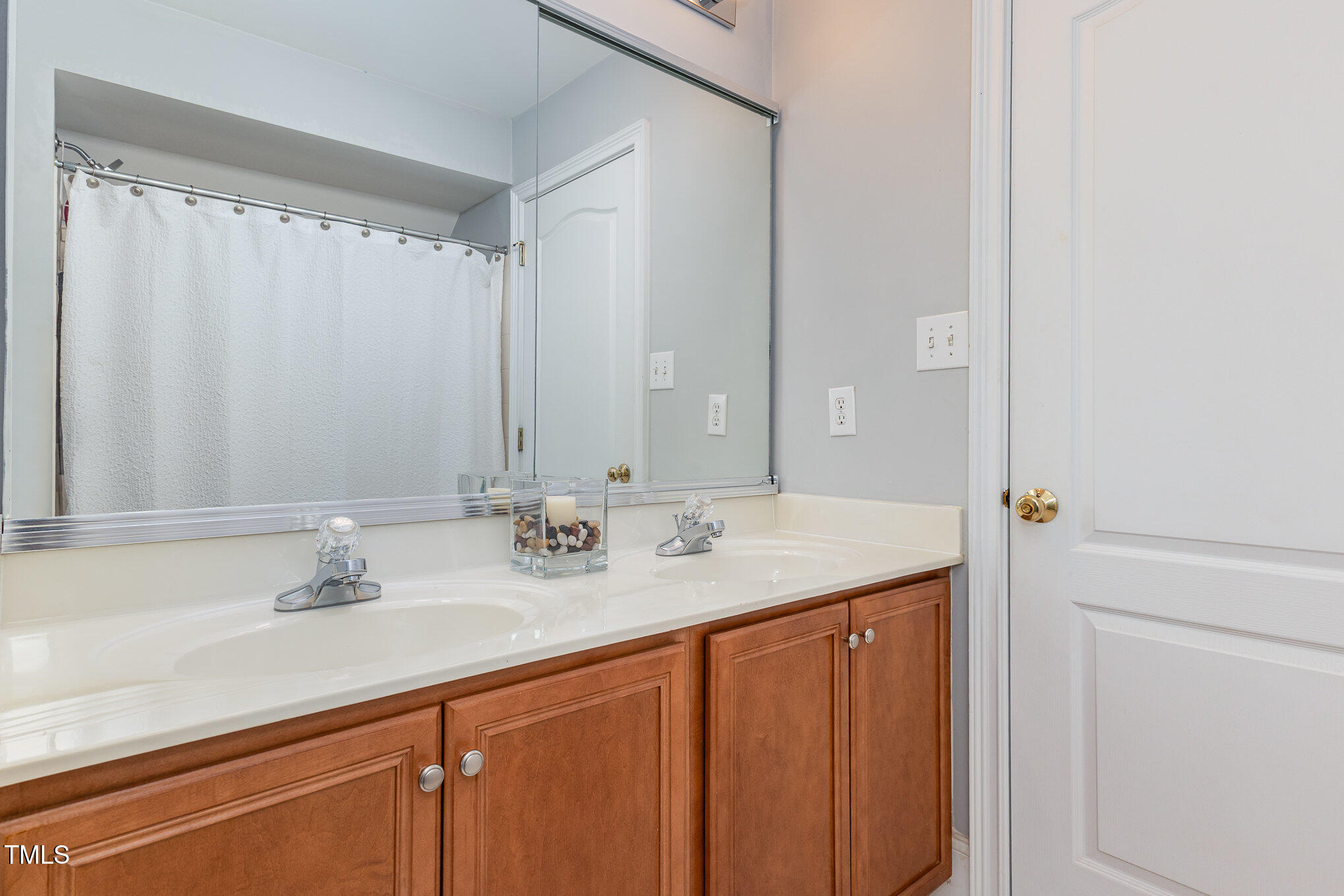 10841 Round Brook Circle Raleigh, NC 27617 - Photo 28 of 44 a bathroom with a double vanity sink and a mirror